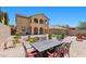 Inviting backyard with an outdoor dining area, fire pit, and well-manicured landscaping at 465 Cabral Peak St, Las Vegas, NV 89138