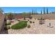 Expansive backyard with manicured landscaping, mature trees, a fire pit, and seating areas at 465 Cabral Peak St, Las Vegas, NV 89138