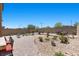 Extensive backyard with manicured landscaping, multiple seating areas, and lush vegetation at 465 Cabral Peak St, Las Vegas, NV 89138