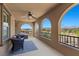 A covered balcony with three arched windows offers stunning views and features seating and a ceiling fan at 465 Cabral Peak St, Las Vegas, NV 89138