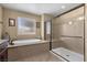 A bright bathroom features a separate shower and soaking tub, complemented by neutral finishes and natural light at 465 Cabral Peak St, Las Vegas, NV 89138