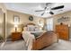 Charming bedroom with wooden furniture, ceiling fan, carpet, and a doorway leading to other rooms at 465 Cabral Peak St, Las Vegas, NV 89138