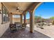 Spacious covered patio with a ceiling fan, comfortable seating, and views of the beautiful backyard at 465 Cabral Peak St, Las Vegas, NV 89138