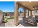 Covered patio featuring an arched design, stylish seating and beautiful landscaping views at 465 Cabral Peak St, Las Vegas, NV 89138
