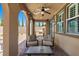 Relaxing covered patio with ceiling fan, outdoor seating, and a view of the landscaped backyard at 465 Cabral Peak St, Las Vegas, NV 89138