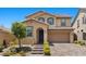 Inviting two-story home features a manicured front yard, brick driveway, and attached garage at 465 Cabral Peak St, Las Vegas, NV 89138