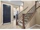 Inviting home foyer featuring a dark front door and a staircase with wooden handrails at 465 Cabral Peak St, Las Vegas, NV 89138