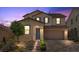 Two-story home featuring manicured landscaping, brick driveway, and a two-car garage at 465 Cabral Peak St, Las Vegas, NV 89138