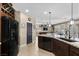 Modern kitchen featuring granite countertops, stainless steel appliances, and an open layout to the living area at 465 Cabral Peak St, Las Vegas, NV 89138