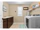 Well-lit laundry room featuring a sink, modern washer and dryer, and ample storage space at 465 Cabral Peak St, Las Vegas, NV 89138