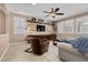 Relaxing living room features a built-in entertainment center, plantation shutters, and comfortable seating for entertainment at 465 Cabral Peak St, Las Vegas, NV 89138