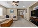 Comfortable living room featuring neutral carpet, a ceiling fan and comfortable seating at 465 Cabral Peak St, Las Vegas, NV 89138