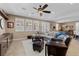 Spacious living room boasts lots of natural light, ceiling fan, and stylish furniture and decor for relaxation at 465 Cabral Peak St, Las Vegas, NV 89138