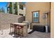 Covered outdoor kitchen with built-in grill, bar seating, and adjacent patio area at 465 Cabral Peak St, Las Vegas, NV 89138