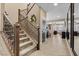 Grand staircase with carpeted steps, wood railing and wrought iron balusters, leading to the upper level at 465 Cabral Peak St, Las Vegas, NV 89138