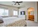 Comfortable bedroom with ensuite bathroom and large windows offering plenty of natural light at 4833 Straight Flush Dr # 103, Las Vegas, NV 89122