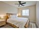 Calm bedroom showcasing a wooden frame bed with a ceiling fan and bright window at 4833 Straight Flush Dr # 103, Las Vegas, NV 89122