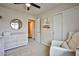 Cozy bedroom with closet, accent mirror, and a comfortable armchair in a neutral color palette at 4833 Straight Flush Dr # 103, Las Vegas, NV 89122