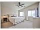 Large bedroom with a ceiling fan, plush carpet, and a comfortable bed near sunny windows at 4833 Straight Flush Dr # 103, Las Vegas, NV 89122