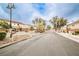 Gated community entrance with lush landscaping and well-maintained streets at 4833 Straight Flush Dr # 103, Las Vegas, NV 89122
