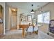 Cozy dining room with modern table and chairs, bright window, and stylish decor accents at 4833 Straight Flush Dr # 103, Las Vegas, NV 89122