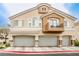 Inviting multi-level townhome featuring a private balcony and attached two-car garage at 4833 Straight Flush Dr # 103, Las Vegas, NV 89122