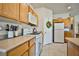 Bright kitchen with white appliances, wood cabinets, and granite countertops, perfect for cooking at 4833 Straight Flush Dr # 103, Las Vegas, NV 89122