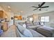 Open-concept living area featuring a comfortable sectional sofa, ceiling fan, and views into the kitchen at 4833 Straight Flush Dr # 103, Las Vegas, NV 89122
