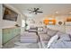 Cozy living room with a large sectional couch, ceiling fan, and built-in storage at 4833 Straight Flush Dr # 103, Las Vegas, NV 89122