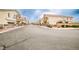 A charming street view showcases well-maintained townhomes with garages in a desirable community at 4833 Straight Flush Dr # 103, Las Vegas, NV 89122