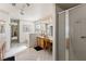 Bright bathroom with dual sinks, a walk-in shower, and natural lighting at 5104 Burr Oak Dr, Las Vegas, NV 89130