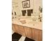 Bathroom vanity with double sinks, wooden cabinets, large mirror, and decorative towels at 5104 Burr Oak Dr, Las Vegas, NV 89130
