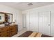 Bedroom with neutral walls, carpet flooring, dresser with mirror, and closet with bi-fold doors at 5104 Burr Oak Dr, Las Vegas, NV 89130