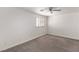 Spacious bedroom with plush carpeting, plantation shutters, and ceiling fan at 5104 Burr Oak Dr, Las Vegas, NV 89130