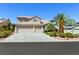 Beautiful two-story home featuring a lush, landscaped yard with a two car garage at 5104 Burr Oak Dr, Las Vegas, NV 89130