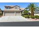 Beautiful two-story home featuring a lush, landscaped yard with a two car garage at 5104 Burr Oak Dr, Las Vegas, NV 89130
