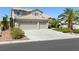 Beautiful two-story home featuring a lush, landscaped yard with a two car garage at 5104 Burr Oak Dr, Las Vegas, NV 89130