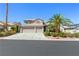 Beautiful two-story home featuring a lush, landscaped yard with a two car garage at 5104 Burr Oak Dr, Las Vegas, NV 89130