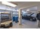 Spacious three-car garage with painted walls, recessed lighting, golf cart and a black car at 5104 Burr Oak Dr, Las Vegas, NV 89130