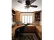 Cozy home office with built-in wooden cabinets, desk space, and a ceiling fan at 5104 Burr Oak Dr, Las Vegas, NV 89130