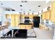 Spacious kitchen featuring wood cabinets, granite countertops and stainless steel appliances at 5104 Burr Oak Dr, Las Vegas, NV 89130