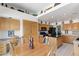 Spacious kitchen with wood cabinetry, black appliances, and a center island at 5104 Burr Oak Dr, Las Vegas, NV 89130