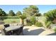 Relaxing outdoor patio with dining table and chairs, overlooking a green golf course at 5104 Burr Oak Dr, Las Vegas, NV 89130