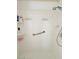 Clean shower featuring white tile, safety bar, and shower head at 5104 Burr Oak Dr, Las Vegas, NV 89130