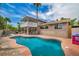Enjoy this backyard oasis with a refreshing pool, balcony, and outdoor dining area ideal for relaxation at 601 Cragin Park Dr, Las Vegas, NV 89107