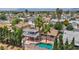 Aerial view of a private backyard with an inviting in-ground pool, lush greenery, and a charming balcony at 601 Cragin Park Dr, Las Vegas, NV 89107