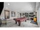 Large basement area with a pool table, exercise equipment, and tiled floors, perfect for entertainment at 601 Cragin Park Dr, Las Vegas, NV 89107