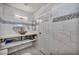 Bathroom featuring a white vanity with a gold sink and white marble-like tiling at 601 Cragin Park Dr, Las Vegas, NV 89107