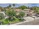 Inviting two-story home featuring a lush front yard, mature trees, and a spacious driveway with a parked car at 601 Cragin Park Dr, Las Vegas, NV 89107