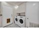 Well-equipped laundry room with modern washer and dryer, and convenient storage for laundry essentials at 601 Cragin Park Dr, Las Vegas, NV 89107